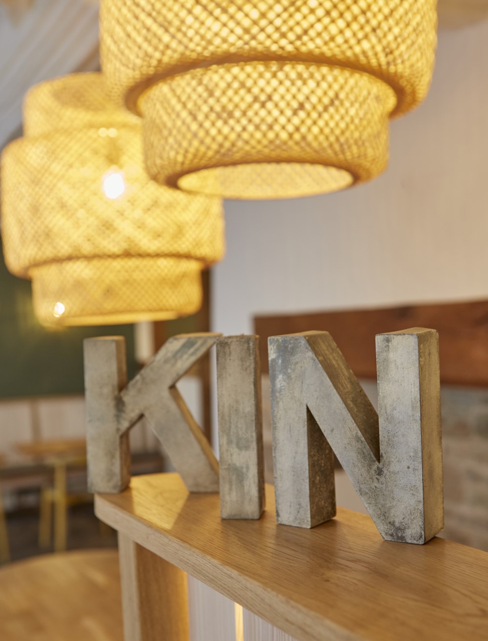 The Letters 'K', 'I', 'N' in wood on the front counter